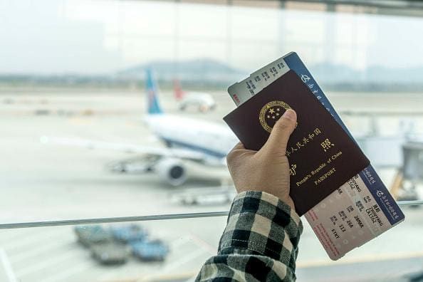 Traveler holding a passport and boarding pass at the airport
